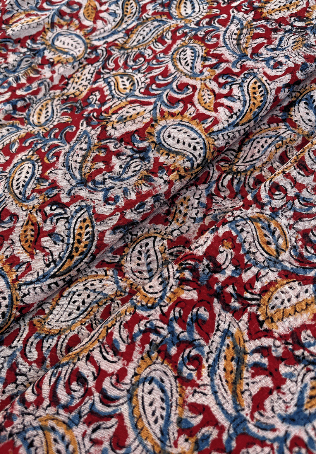Paisley Kalamkari Print on Red Fabric with Blue and Mustard Accents
