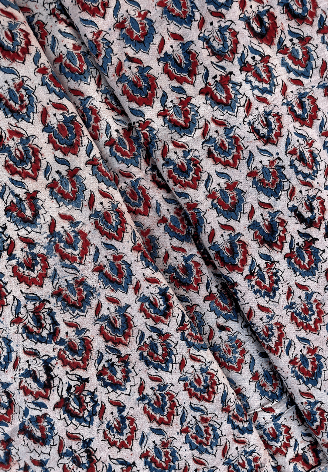 Floral Kalamkari Print on White Fabric with Red and Blue Accents