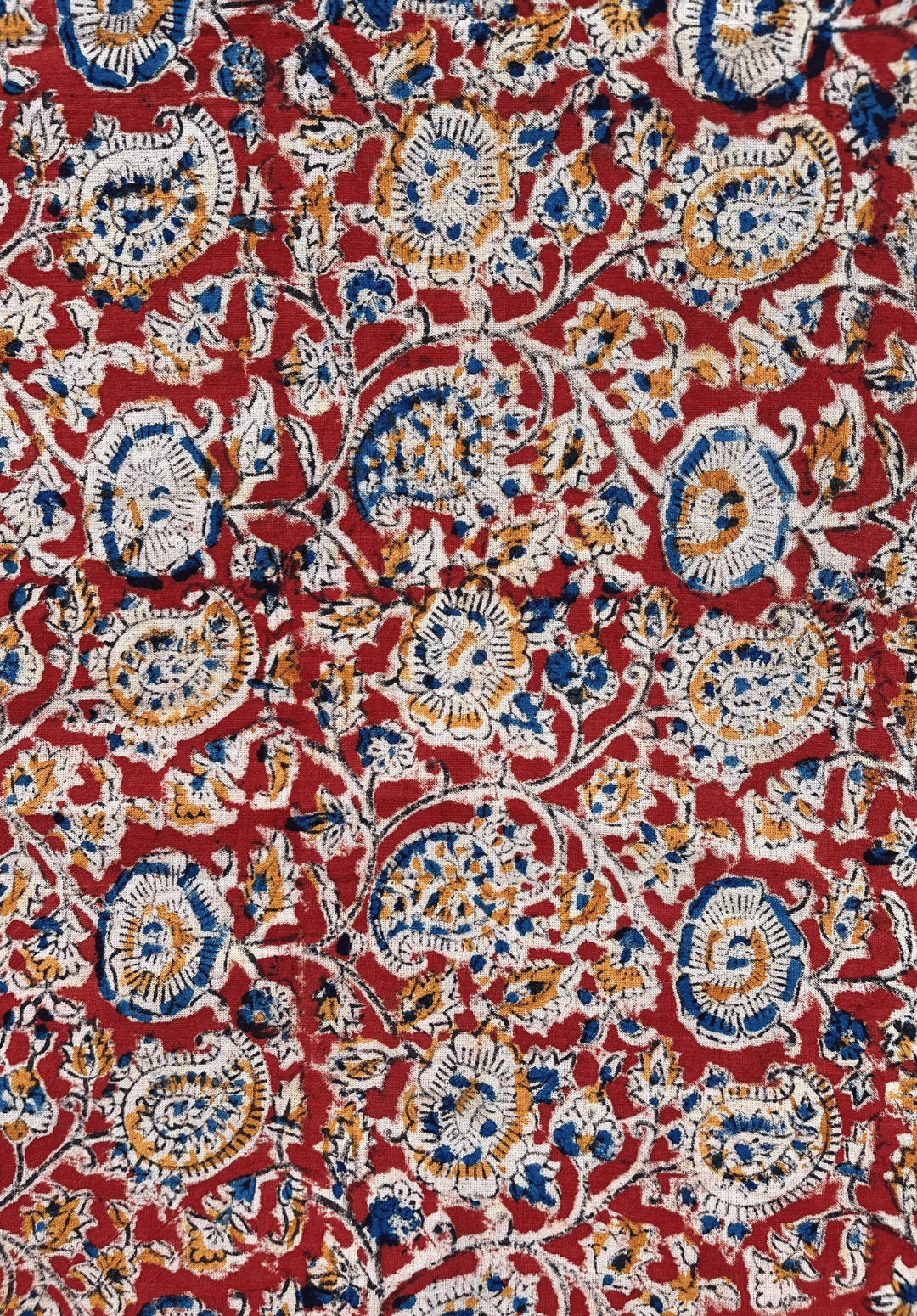 Traditional Paisley and Floral Kalamkari Print on Red Fabric with Blue, White, and Mustard Accents