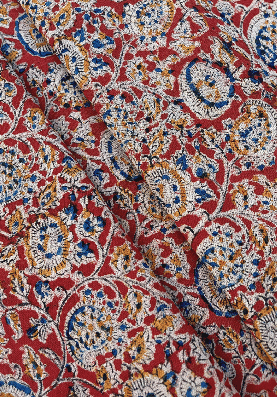 Traditional Paisley and Floral Kalamkari Print on Red Fabric with Blue, White, and Mustard Accents