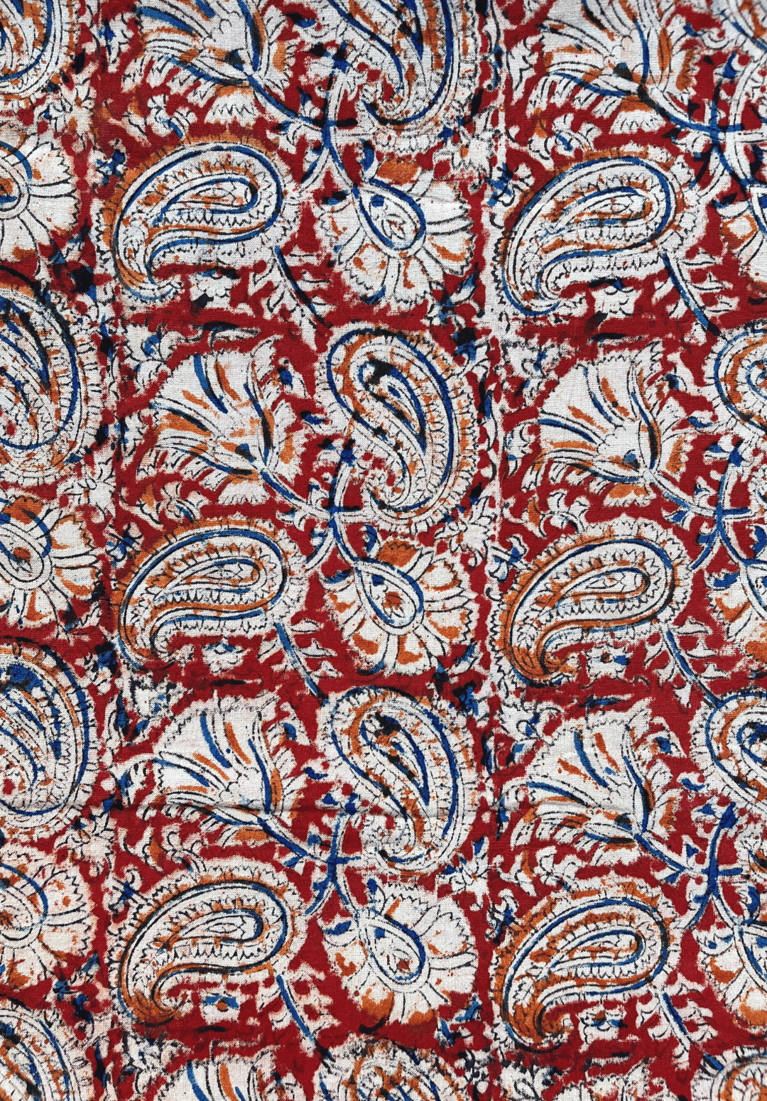 Traditional Kalamkari Fabric with Paisley and Floral Motifs on a Red Background