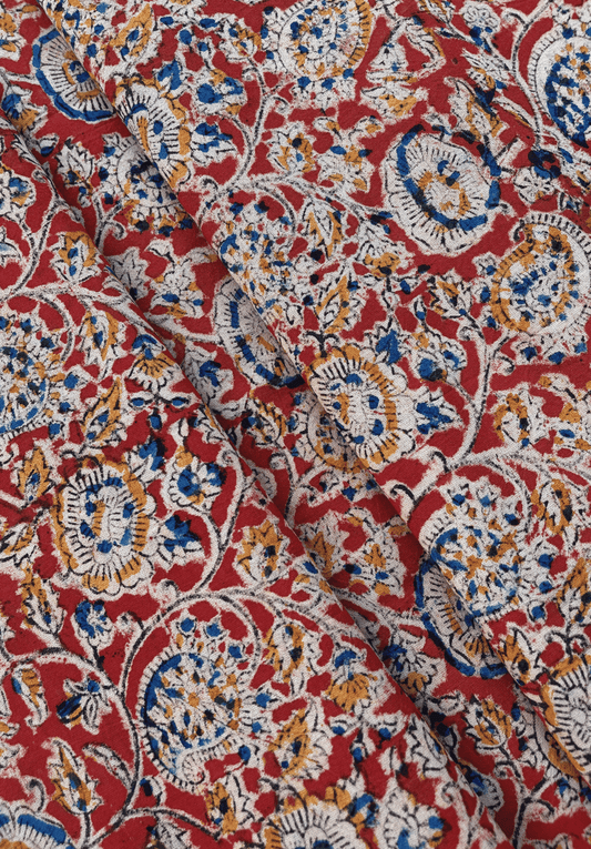 Traditional Paisley and Floral Kalamkari Print on Red Fabric with Blue, White, and Mustard Accents